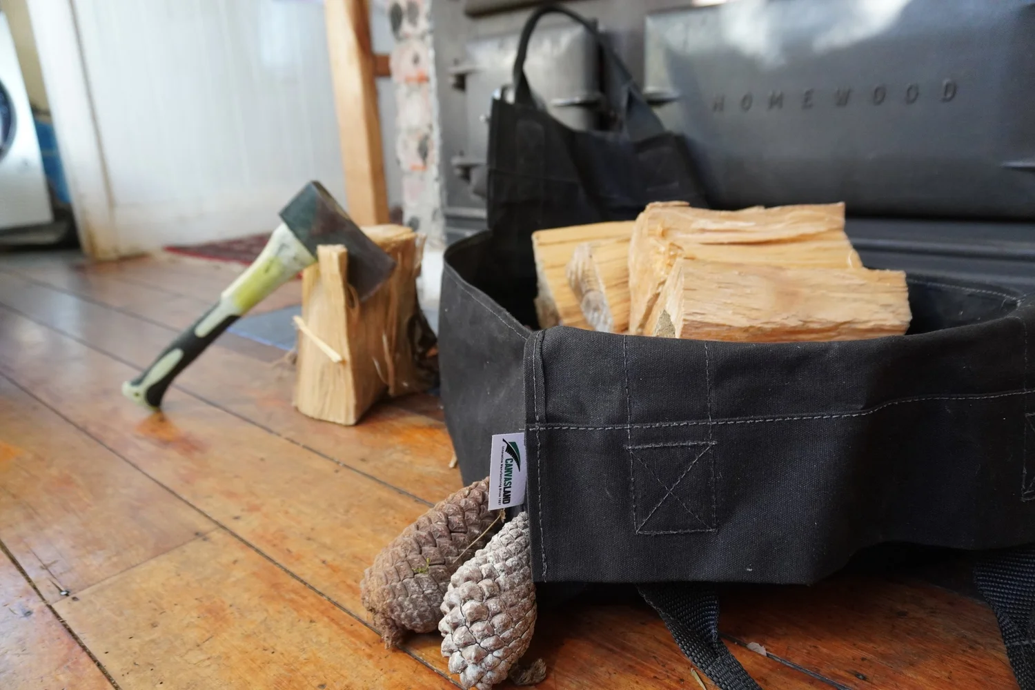 Canvas firewood carrier loaded with split firewood