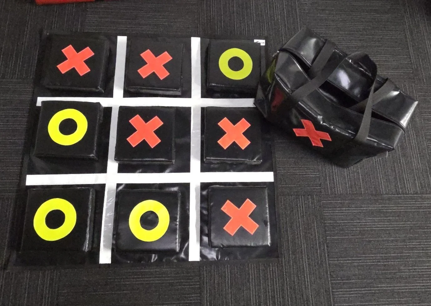 Large outdoor noughts and crosses game set up on a lawn