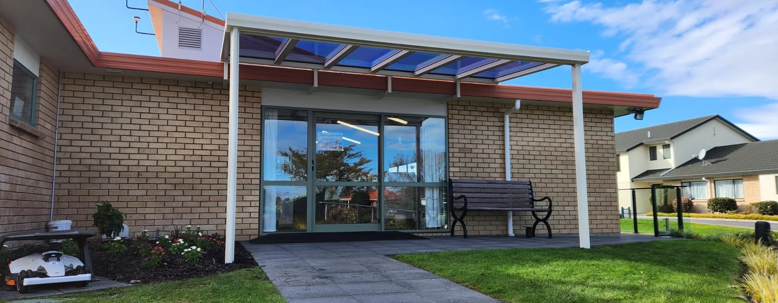 Acrylic sheet roof over an entranceway at a retirement village