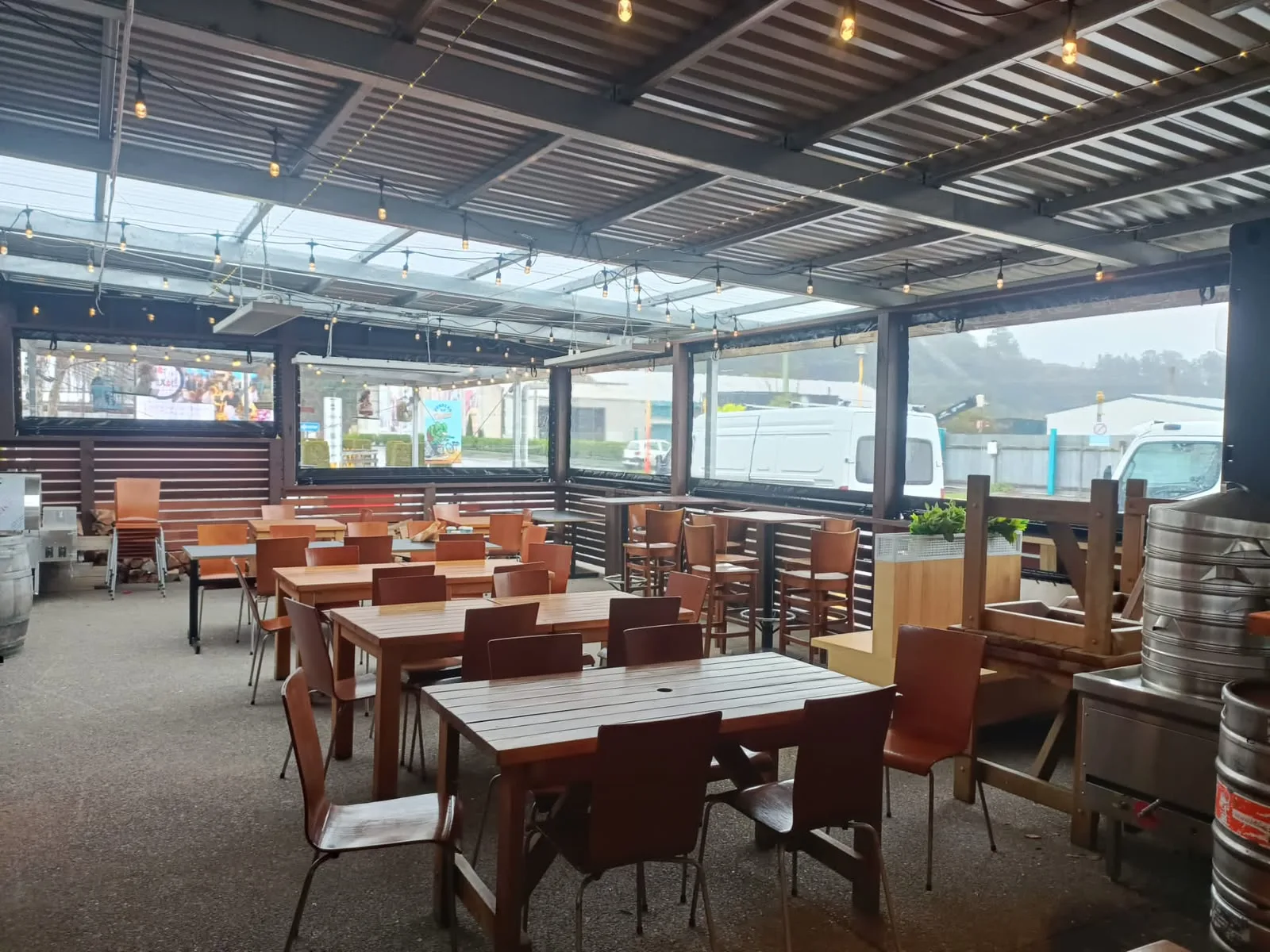 Clear PVC screens enclosing a bar outdoor dining area