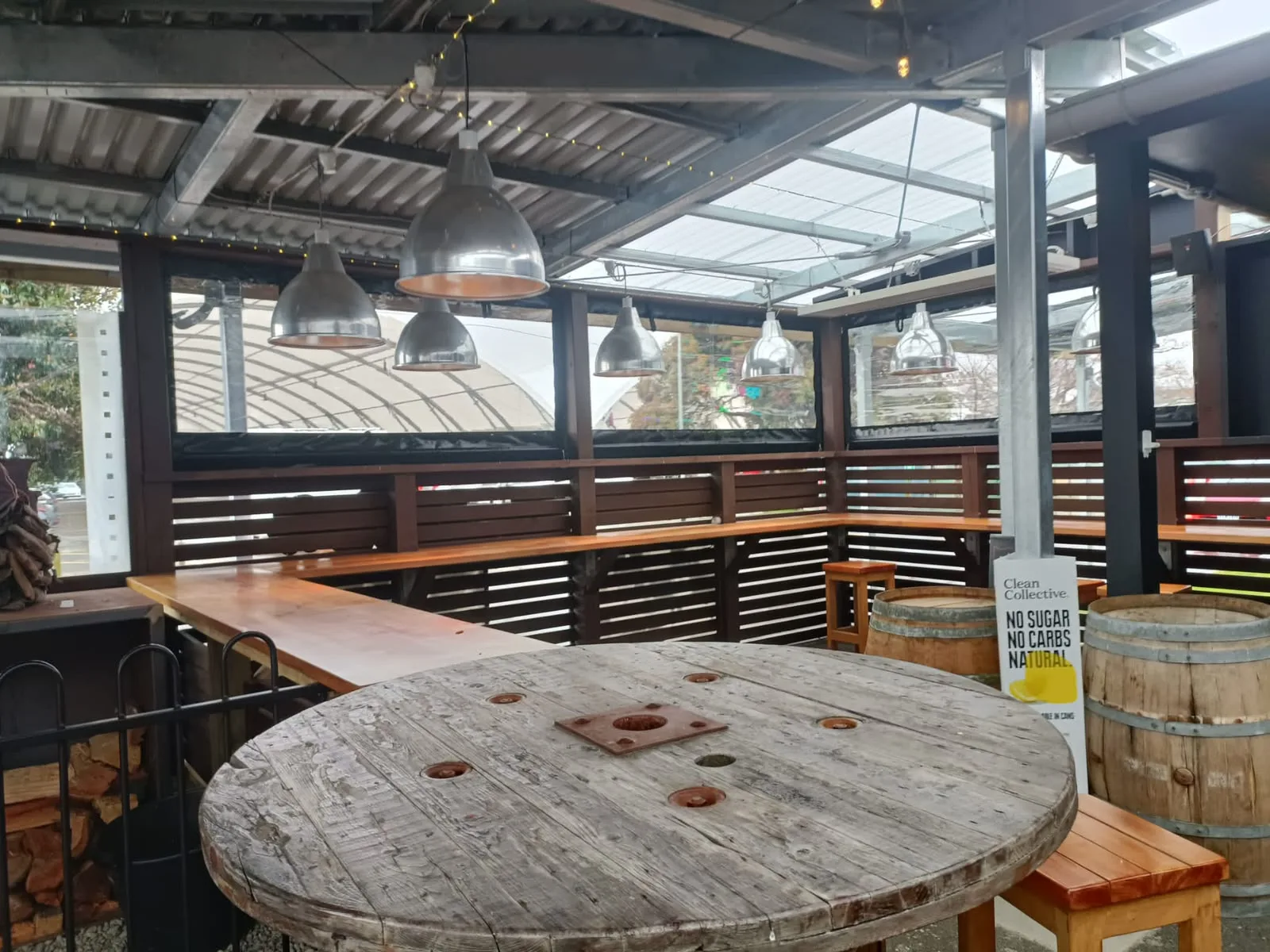 Clear screens along a commercial deck, open to the view but out of the wind