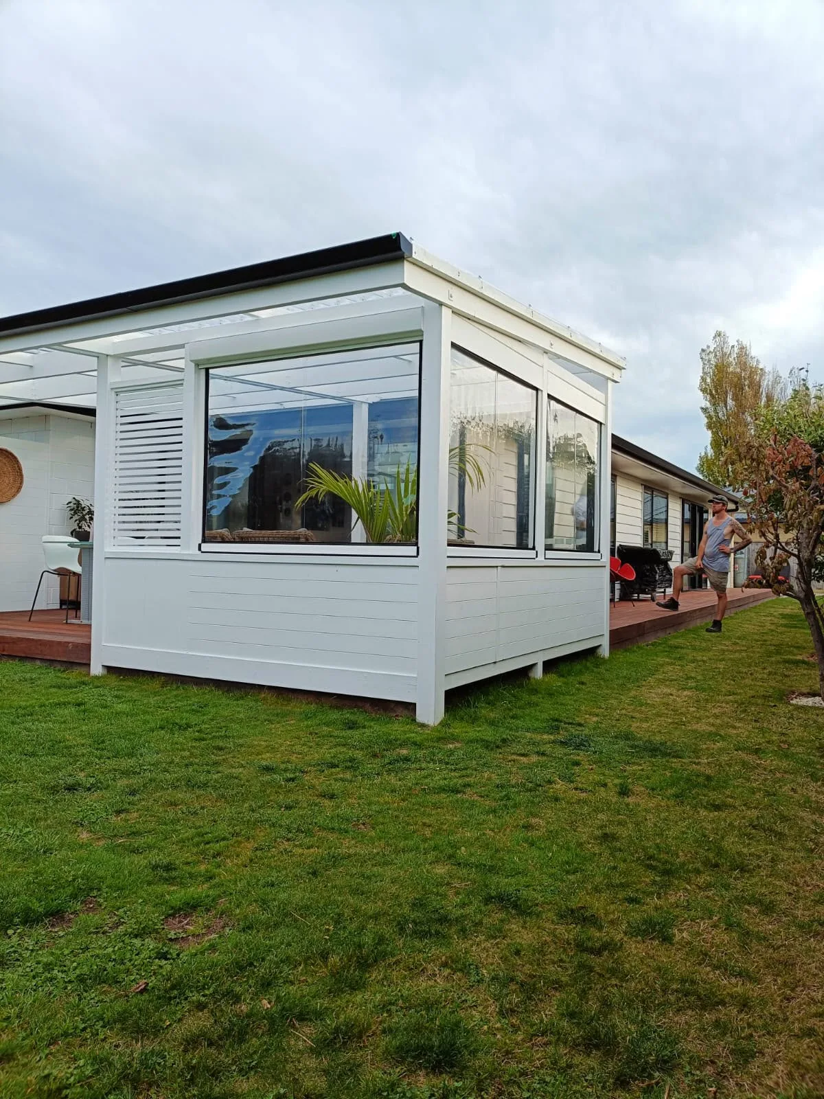 White outdoor room with clear PVC screens on three sides