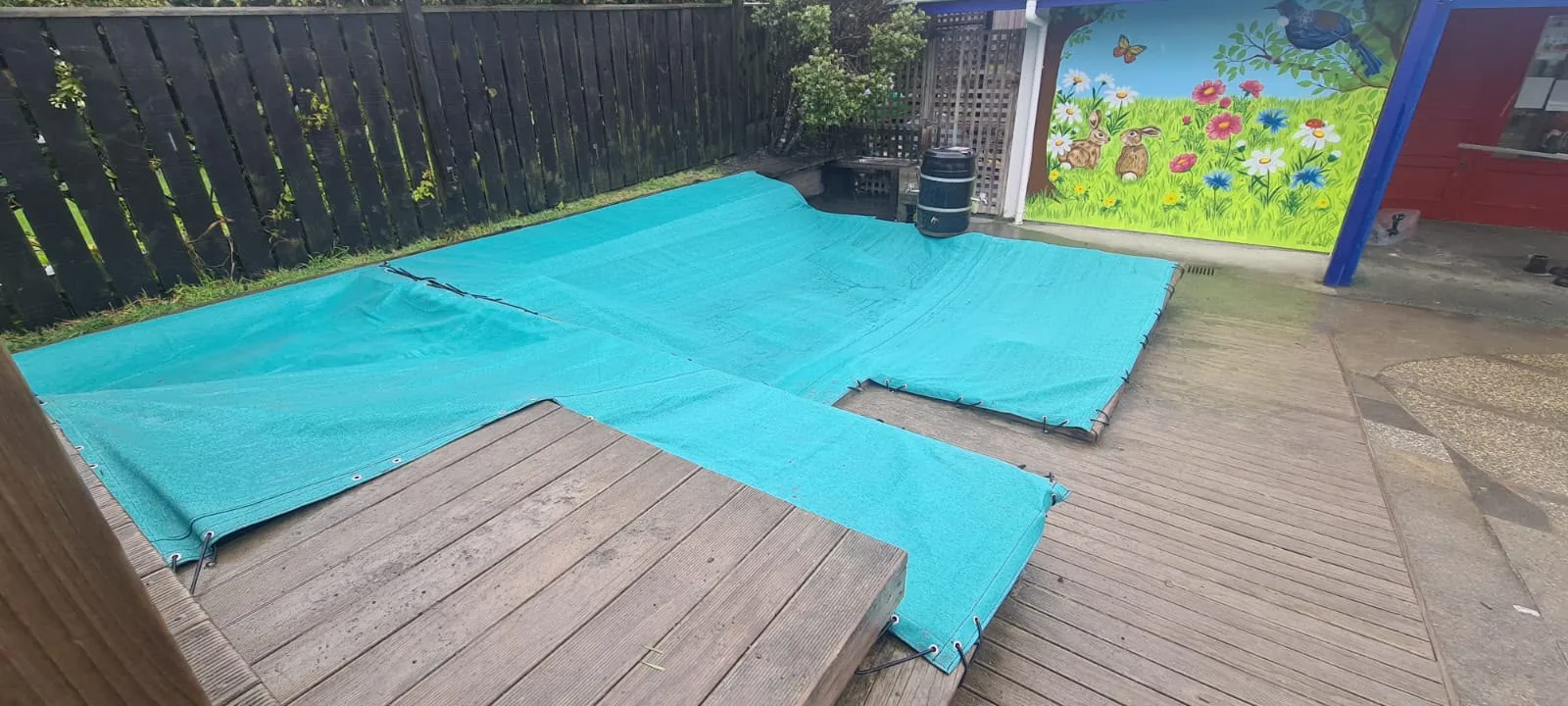 Teal sandpit covers protecting two sandpits at an early childhood centre