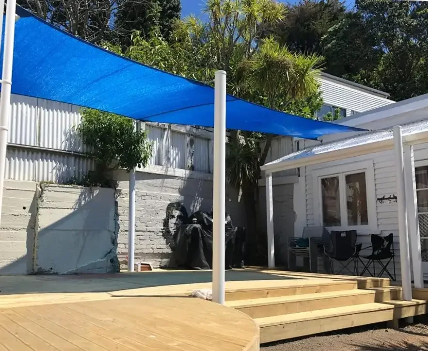 Blue shade sail over a courtyard deck