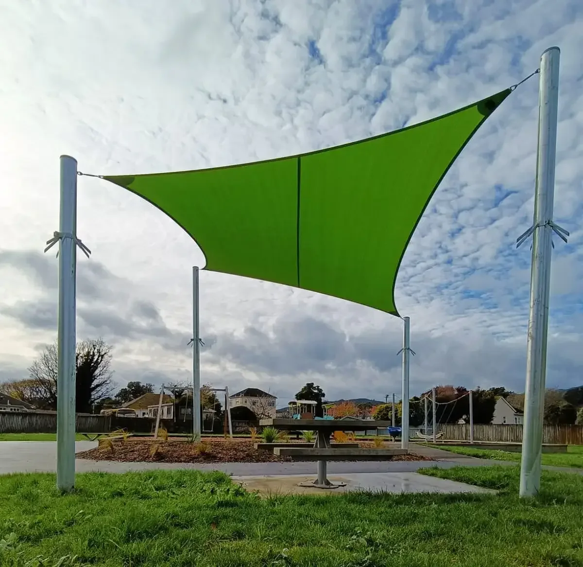 Bright green shade sails over a school playground and picnic area