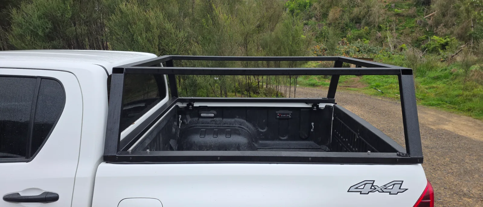 Welded steel canopy frame mounted to a ute deck with the tray open