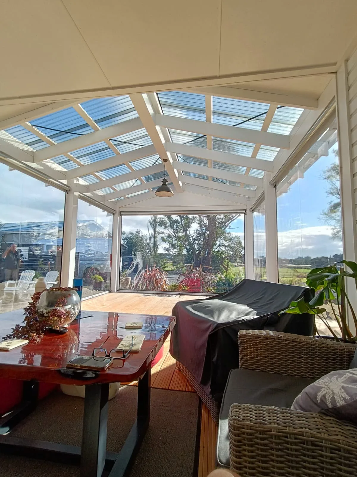 Ziptrak blinds sheltering an outdoor lounge and dining setting